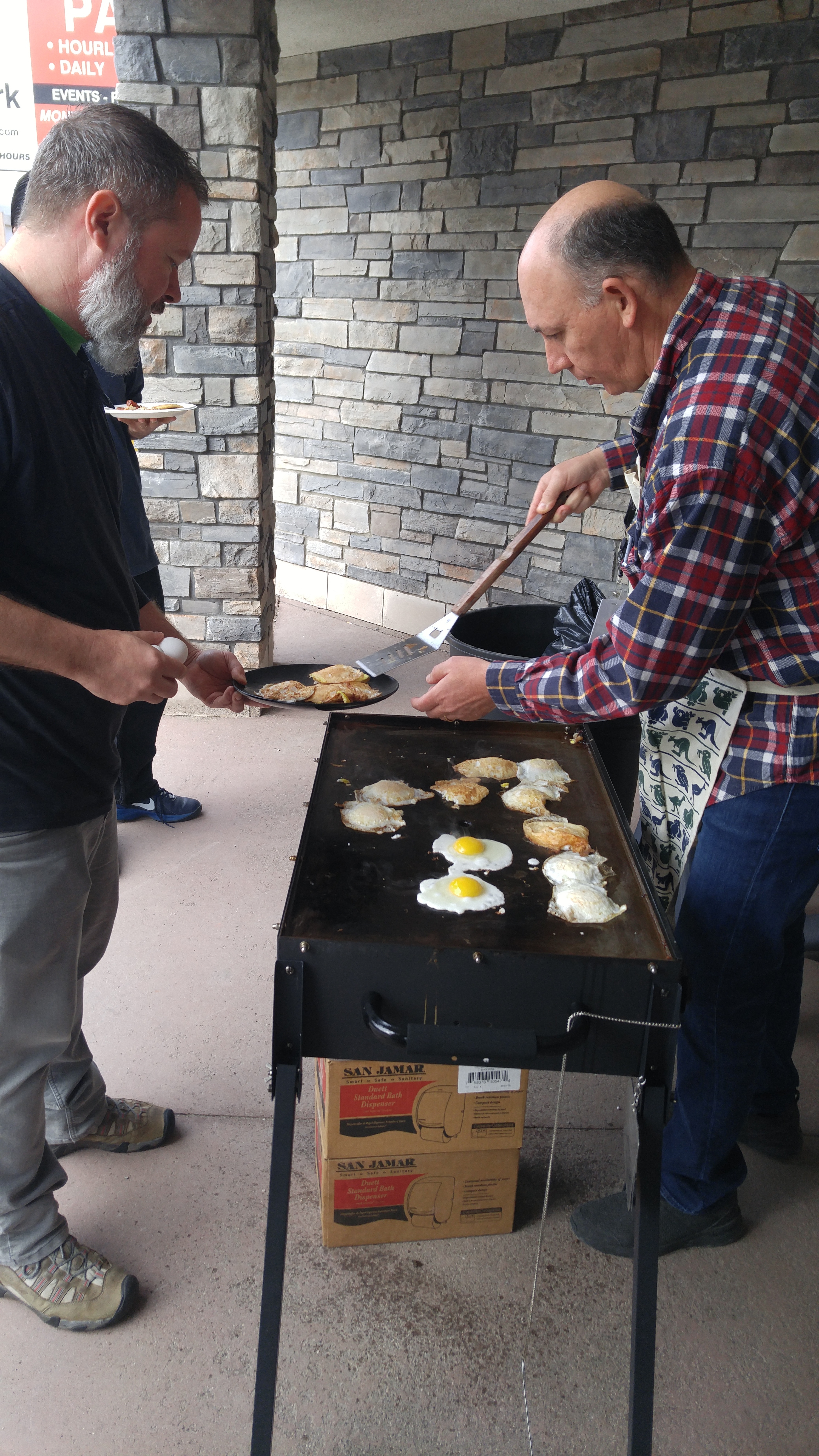 Warren cooking eggs and giving them to Chris