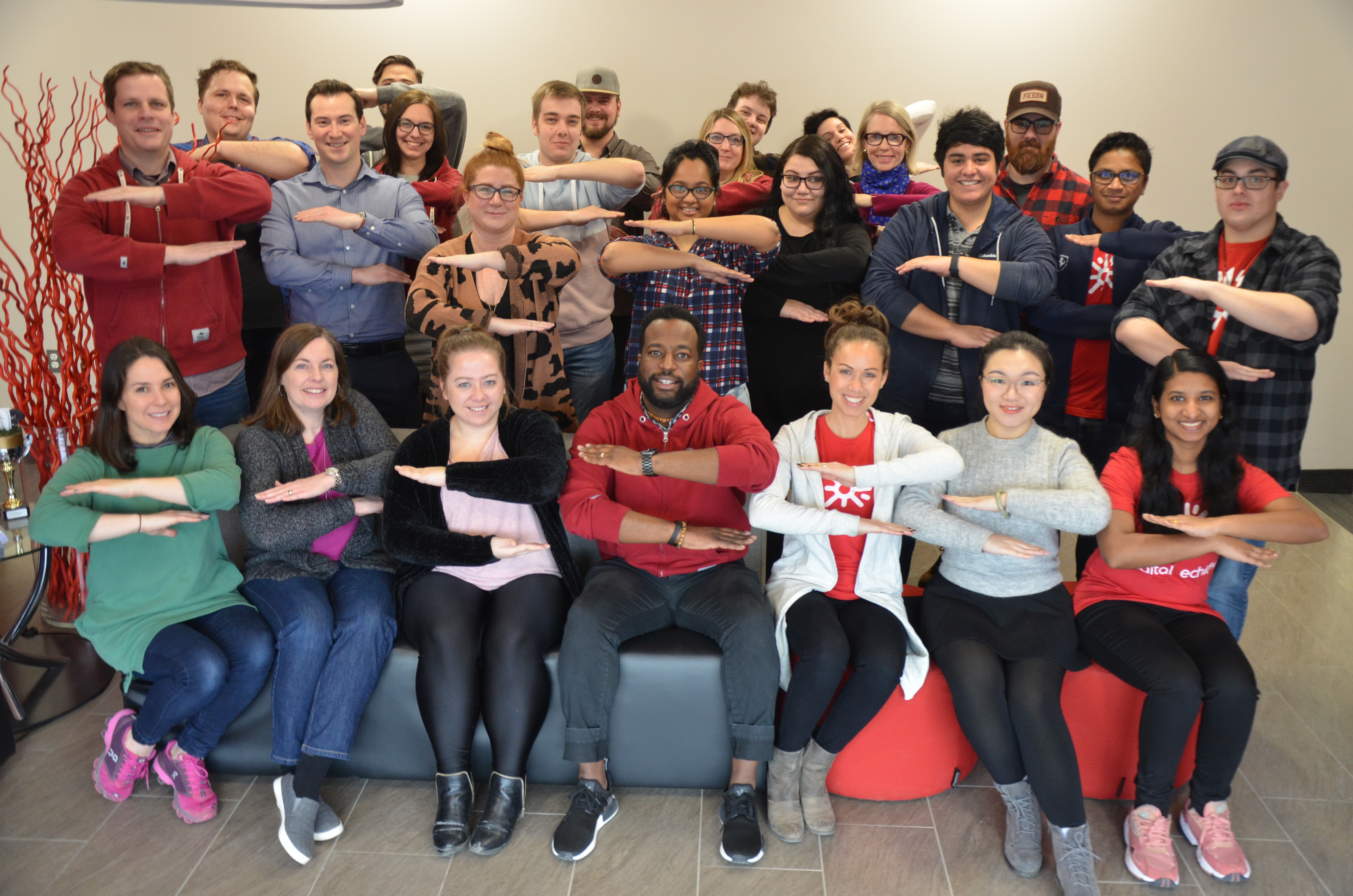 group together with arms out front at right angle to the body, elbows bent and palms down to make an equal sign