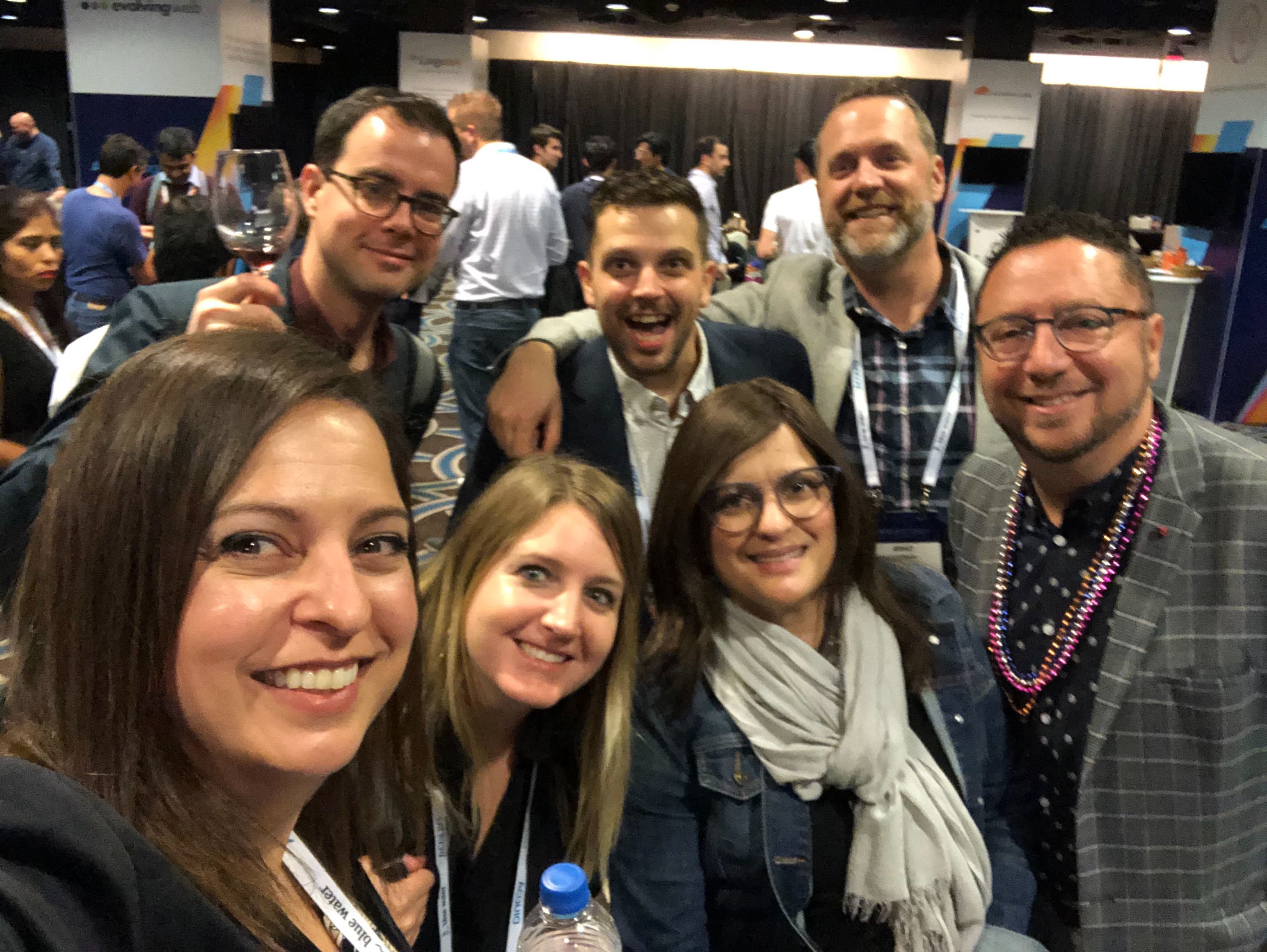 group of people smiling, looking at camera.