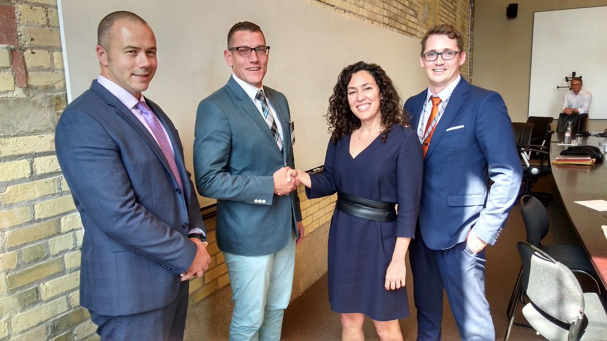 Digital Echidna's Michael Grant shakes hands with the Open Government Canada team.