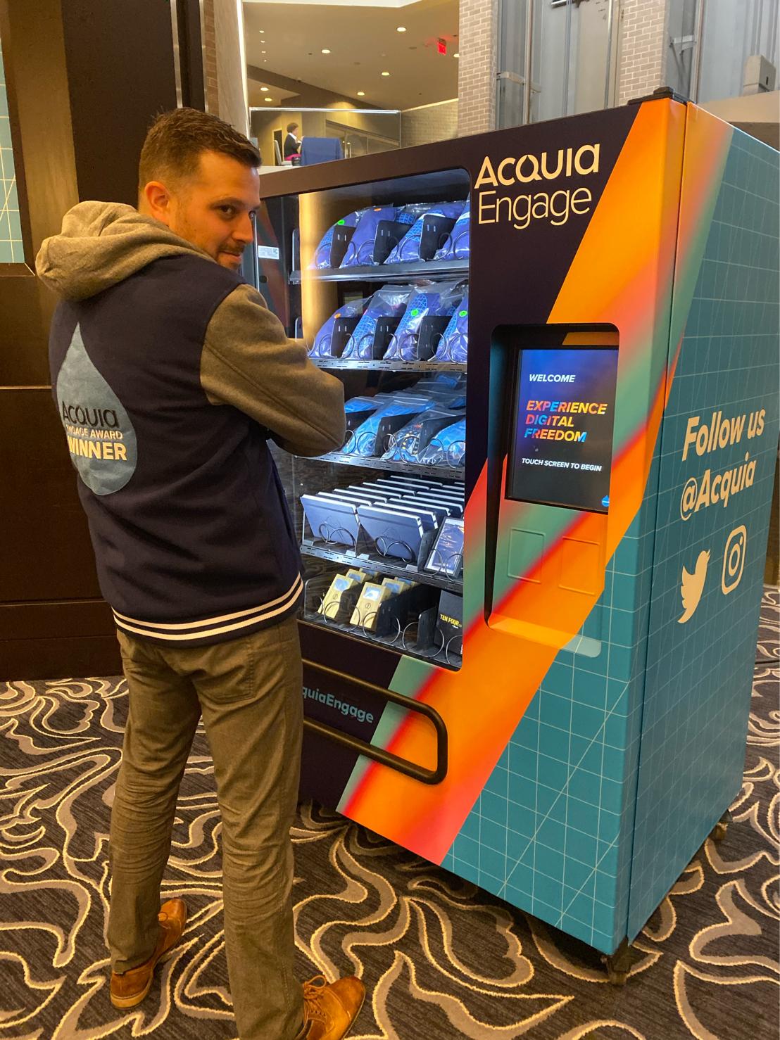 man with back to camera, jacket says Winners Acquia