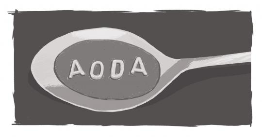 A soup spoon with alphabet soup letters spelling AODA 